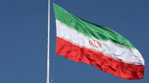 In this image the Iranian flag can be seen flying over a street in Tehran, Iran, on February 3, 2023