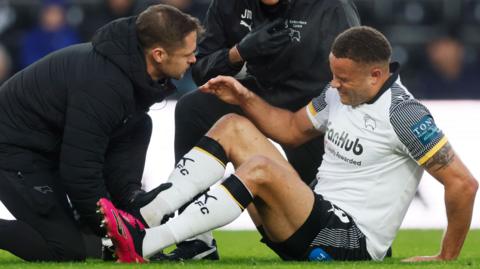 Derby's Carlton Morris receives treatment during the game against Watford
