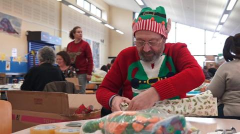 Volunteer wrapping presents