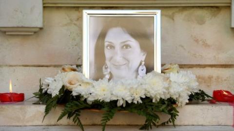 Flowers and tributes lay next to a picture of Daphne Caruana Galizia in Valletta. Photo: 19 October 2017