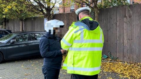 PC Joshua Ace talking to an offending motorcyclist in Leicester
