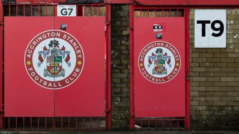 Doors at Accrington Stanley's Wham Stadium displaying their badge