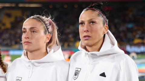 Alexia Putellas and Jennifer Hermoso of Spain line up for the national anthem