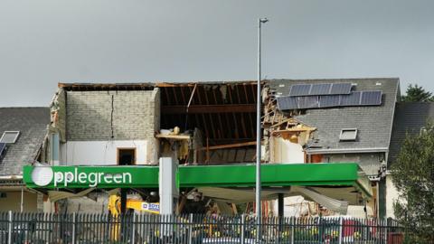 The scene of the blast, the Applegreen sign outside the garage is destroyed alongside the building. 