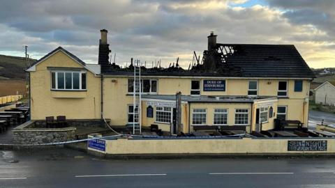 The burnt out roof of the Duke of Edinburgh pub in Newgale, Pembrokeshire