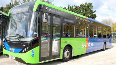 A green bus with Swindon's bus company logo on it