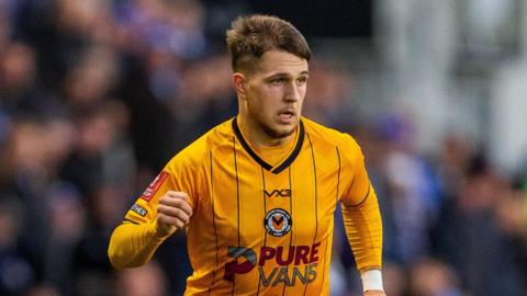 Lewis Payne running with the ball during a game for Newport