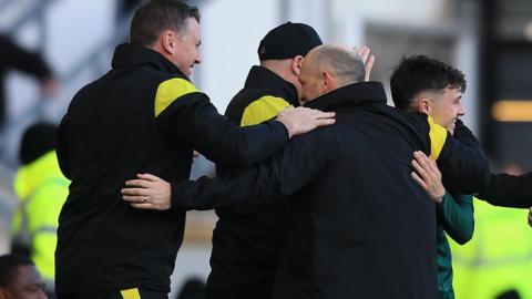 Alex Neil celebrates Josh Coburn's injury-time winner with his backroom team