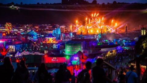 General view of the crowd, stage and lightshow during a performance after dark at Boomtown Festival, Matterley Estate in South Downs National Park, near Winchester, Hampshire