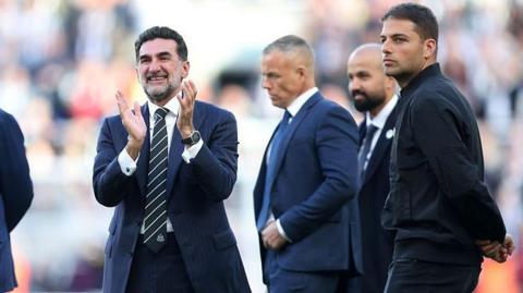 Newcastle United co-owner, Mehrdad Ghodoussi applauds the fans alongside Jamie Reuban