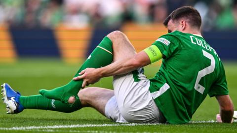 Seamus Coleman clutches his left ankle area