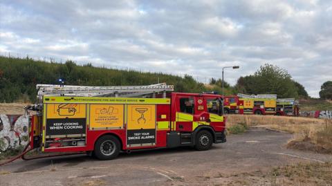 A fire engine on a piece of scrubland