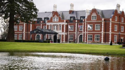 The outside of the Fairmont Hotel with a lake in the foreground