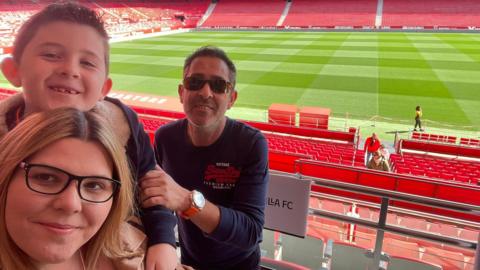 Gemma, Eduardo and nine-year-old Edward at Sevilla's stadium in Spain