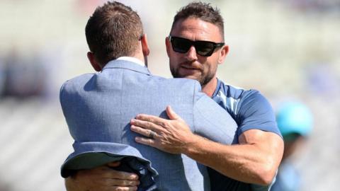 Brendon McCullum is hugged by Eoin Morgan