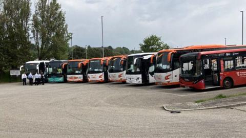 A mixture of visiting coaches and local buses parked at Truro coach park