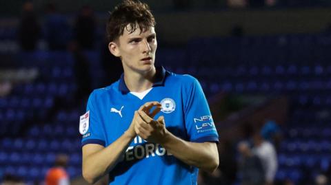 George Nevett applauds Peterborough United's supporters