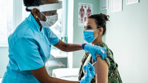 Nurse giving covid vaccine