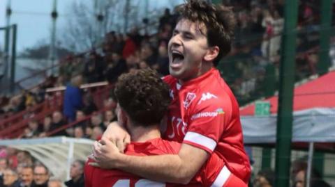 Joe Kilshaw is held aloft by a Jersey Bulls team-mate after scoring