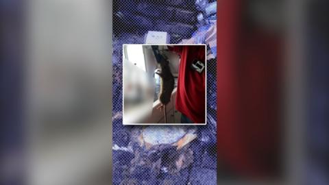 A rat is held up in an image by a trap. A background of rubbish sprawled out on the street - with a blue tint.