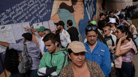 Voters wait in line to cast their vote at Manuel Palacio Fajardo public school in 23 de Enero slum during the presidential election on July 28, 2024 in Caracas, Venezuela. 