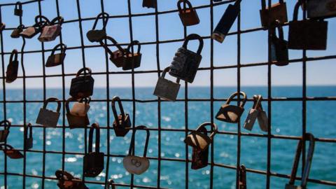 Pad locks attached to a fence 