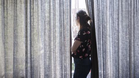 A woman by a window - posed by model