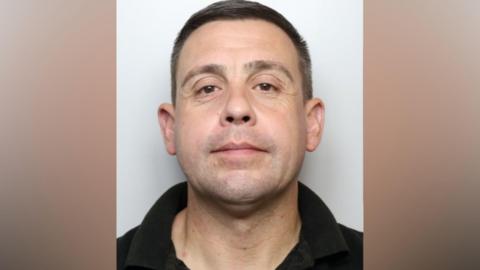 A mugshot of Sale who has brown hair and brown eyes.
