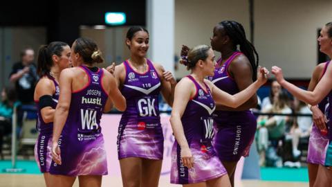 Loughborough Lightning players fist bumping