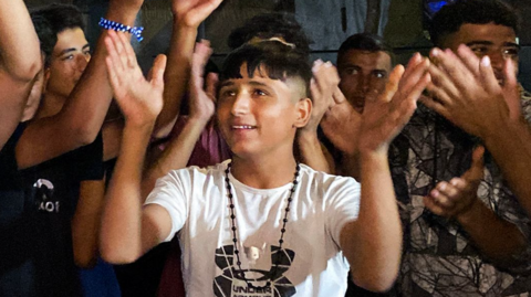 Palestinians celebrate on a street in Khan Younis after Trump's announcement.
