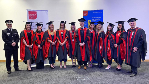 Police graduates in their gowns and mortar boards