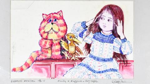 A brightly coloured Peter Firmin illustration showing Bagpuss sitting on a pink cabinet beside Emily, who is wearing a long patterned dress with blue trim. Professor Yaffle perches between them. Bagpuss is painted in pink and orange stripes against a pale background.