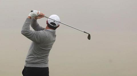 Rory McIlroy in front of a grey background