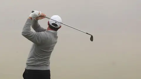 Rory McIlroy in front of a grey background