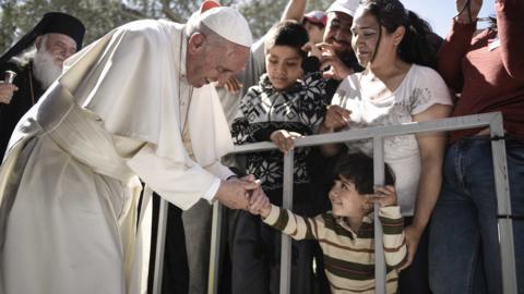 In this handout image provided by Greek Prime Minister's Office, Pope Francis meets migrants at the Moria detention centre on April 16, 2016 in Mytilene, Lesbos, Greece.