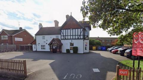 A Google Street View image of the Partou Barnwood Day nursery in Gloucester, Gloucestershire. The building has a mock-Tudor exterior and is largely painted white.
