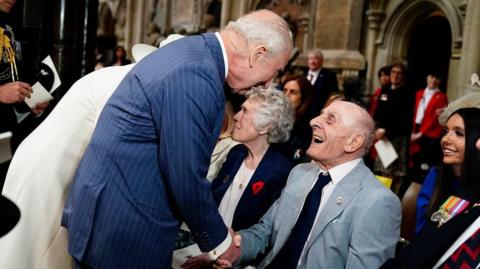 The King greeting a war veteran. 
