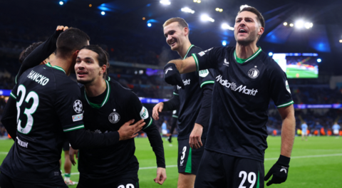 Feyenoord players celebrate after coming from 3-0 down against Manchester City to draw 3-3