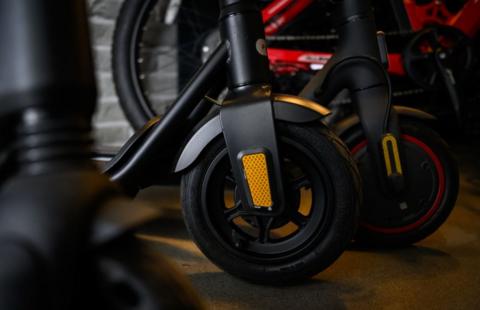 A close up image of the wheels of e-scooters.