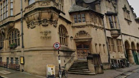 The exterior of the Museum of Oxford, with light-brown stone.
