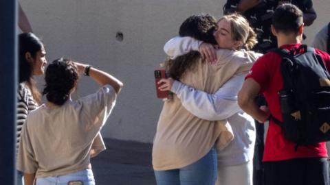 Pepperdine University students embrace at vigil