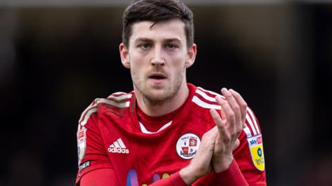 Crawley Town forward Ashley Nadesan applauds during a match