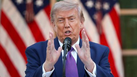 US President Donald Trump wearing a purple tie.