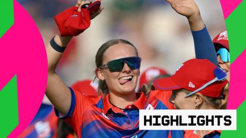 Tilly Corteen-Coleman celebrates with her hands in the air and her tongue poking out