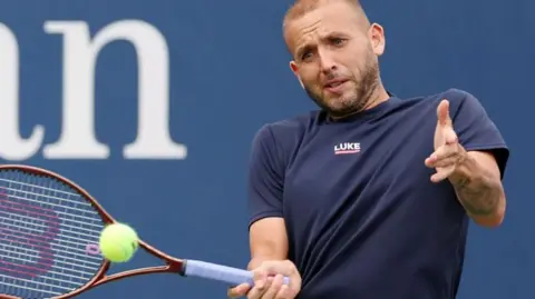 Dan Evans hits a shot