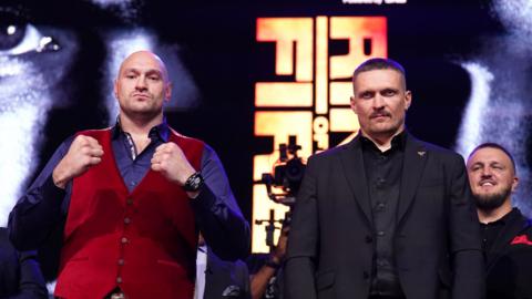 Tyson Fury and Oleksander Usyk pose side by side for pictures