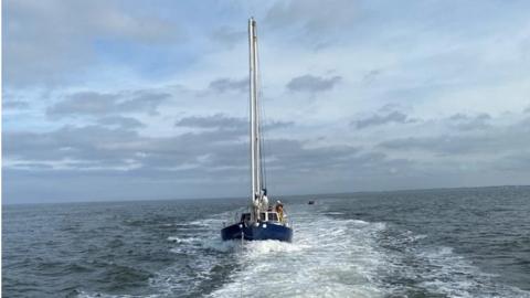 Yacht being towed to safety