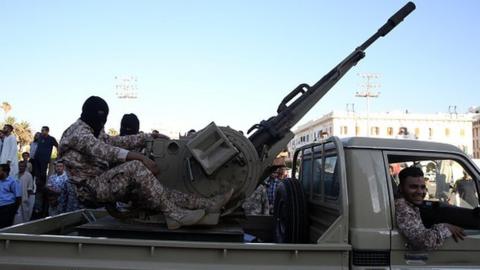 Soldiers march during a military parade to mark fourth anniversary of revolt which ousted dictator Muammar Gaddafi