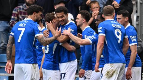Portsmouth celebrate Ibane Bowat's opening goal against Leicester