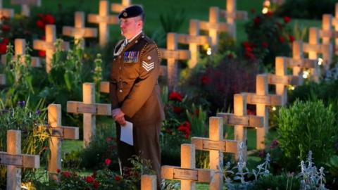 Soldier standing among the crosses of the missing at the Commonwealth War Graves Commission memorial at Thiepval